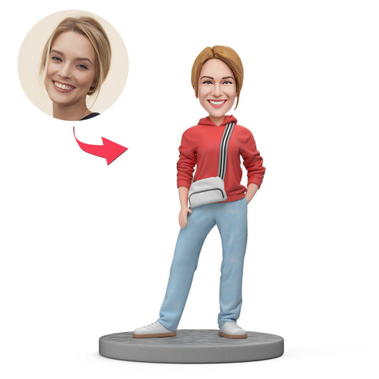 Handcrafted personalised polymer clay bobblehead of a casual woman in a pink top and jeans, with a custom head matched to your photo and option for engraved text — personalised bobblehead gift