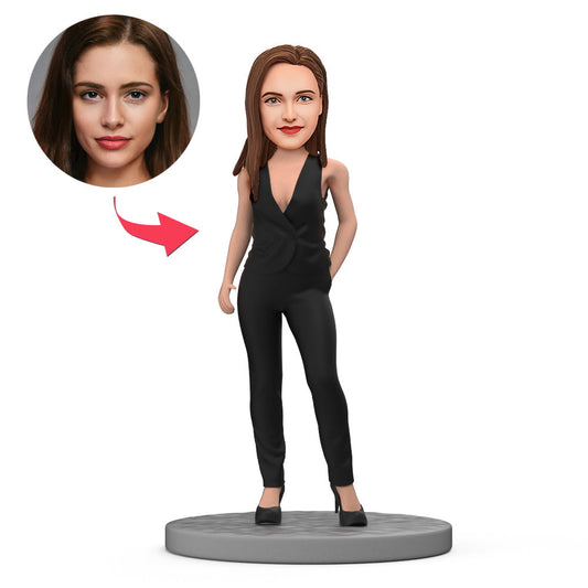 Front view polymer clay customised figurine of a lady in a black one‑piece business suit with a personalised head and engraved text on the base — custom bobblehead for ladies.