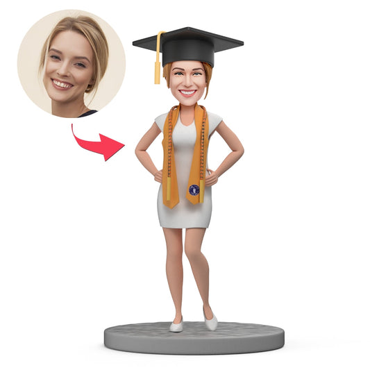 Custom graduation bobblehead of a female graduate wearing an orange stole, handcrafted polymer clay with a customised head from your photos — a personalised graduation gift and keepsake for her