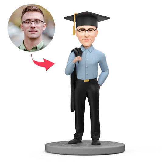 Personalised graduation bobblehead of a cool male graduate with bachelor gown draped over shoulder — custom polymer clay head matched to photo, ideal personalised gift for him