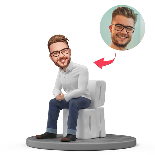 Custom sitting dad bobblehead in durable polymer clay with personalised head and engraved base showing custom text — perfect Father's Day gift for his desk or workspace.