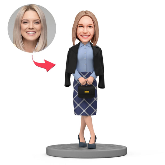 Personalised bobblehead of a stylish woman in a black coat with a bag — handcrafted polymer clay figure with a customisable head, ideal personalised gift