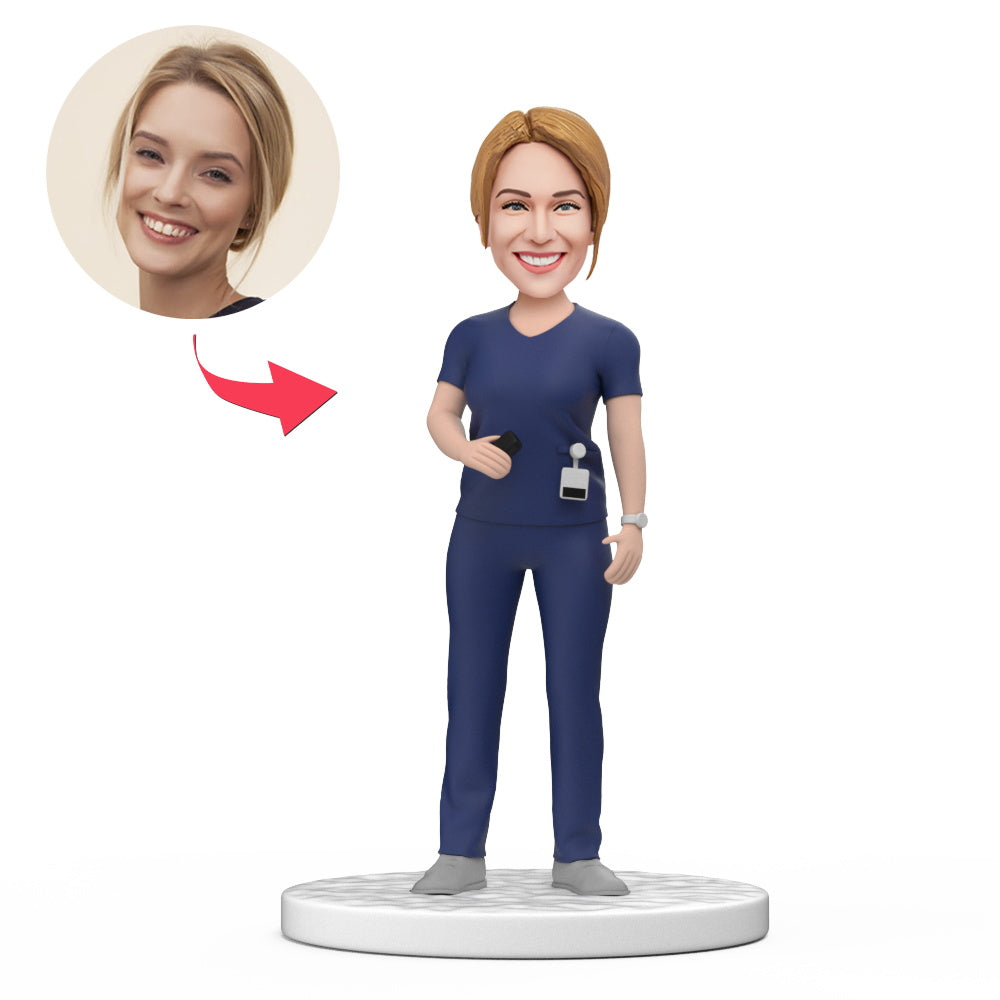 Personalised female doctor bobblehead in dark blue scrubs, handcrafted polymer clay with custom sculpted head and engraved base – perfect medical desk ornament and gift for her