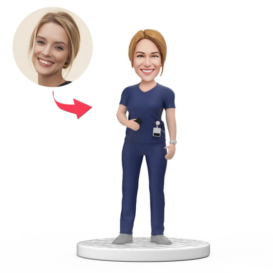 Personalised female doctor bobblehead in dark blue scrubs, handcrafted polymer clay with custom sculpted head and engraved base – perfect medical desk ornament and gift for her