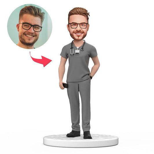 Custom male doctor bobblehead in grey scrubs with engraved base – handmade polymer clay, personalised head sculpted from photos; ideal gift for National Doctor’s Day, medical graduation or birthday (UK & Australia)
