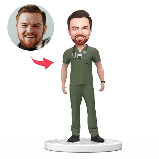 Custom personalised male doctor bobblehead in green scrubs with engraved base, handcrafted polymer clay likeness from your photos — ideal National Doctor's Day gift or medical graduation keepsake for NHS GPs in the UK and Australia