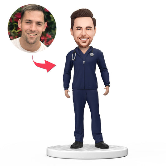 Personalised male doctor bobblehead in blue scrubs with jacket and engraved base, handcrafted polymer clay with custom head from photos — ideal personalised doctor gift for NHS, surgeon or medical graduate (UK & Australia)