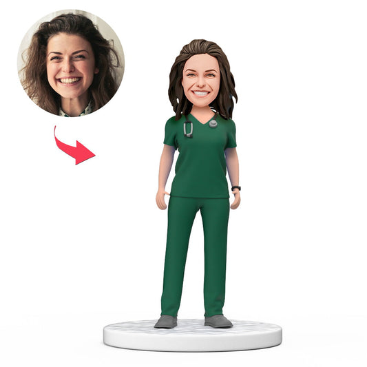 Personalised female doctor bobblehead in green scrubs — handmade polymer clay desk ornament with a custom photo head and engraved base; ideal UK/NHS or Australia thank-you and medical graduation gift