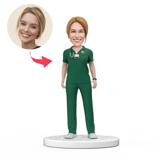 Custom female doctor bobblehead in green scrubs, handmade personalised GP figurine with engraved base and customised head from your photo — perfect personalised medical keepsake gift for doctors, graduations or Mother’s Day (AU/UK)