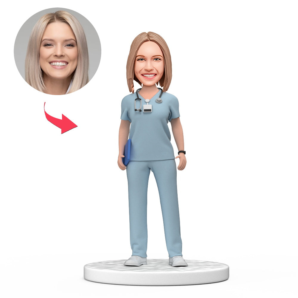 Handmade custom female doctor bobblehead in light blue scrubs with personalised face and engraved base — ideal personalised doctor gift and medical graduation keepsake (UK & AU)
