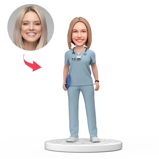 Handmade custom female doctor bobblehead in light blue scrubs with personalised face and engraved base — ideal personalised doctor gift and medical graduation keepsake (UK & AU)