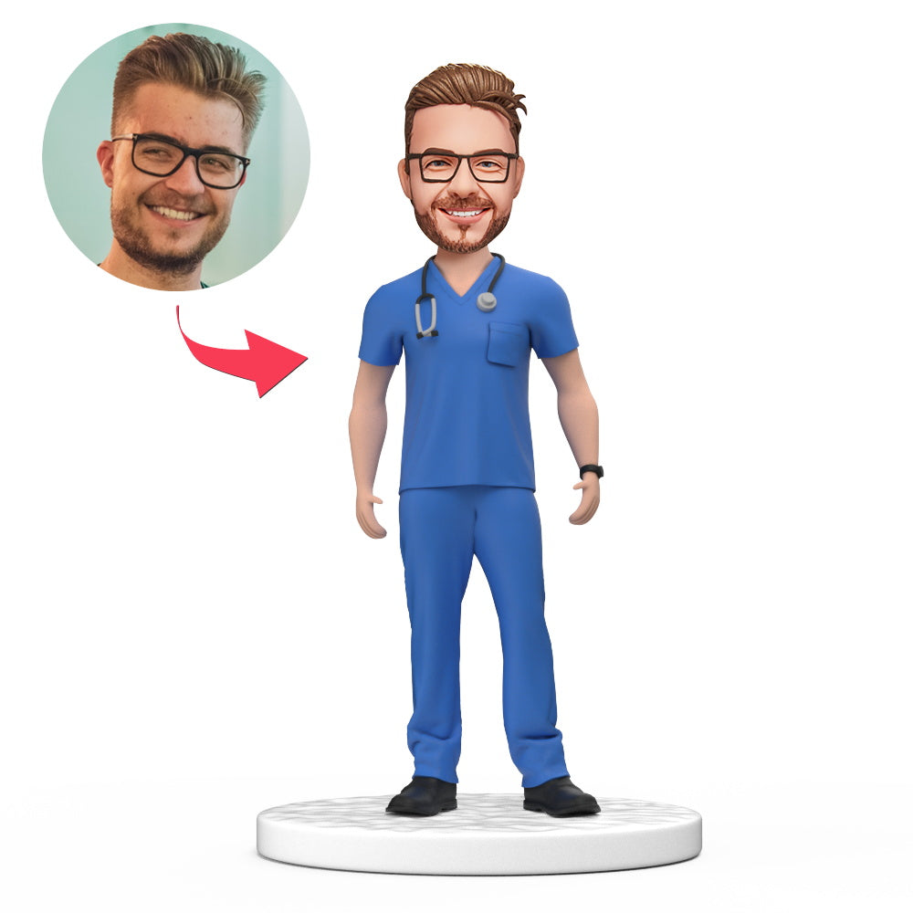 Custom male doctor bobblehead in blue scrubs with personalised engraved base, handmade polymer-clay keepsake — ideal NHS/GP thank-you, medical graduation or personalised doctor gift