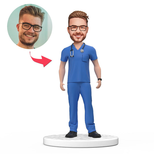 Custom male doctor bobblehead in blue scrubs with personalised engraved base, handmade polymer-clay keepsake — ideal NHS/GP thank-you, medical graduation or personalised doctor gift