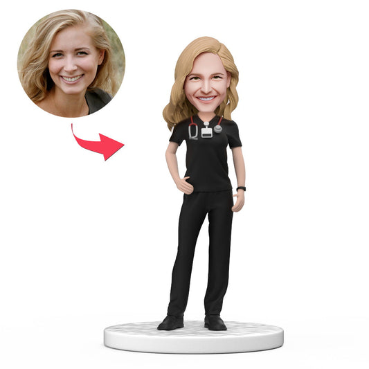 Personalised female doctor bobblehead in black scrubs with engraved base, handmade polymer clay custom face doll – ideal personalised doctor gift and graduation keepsake