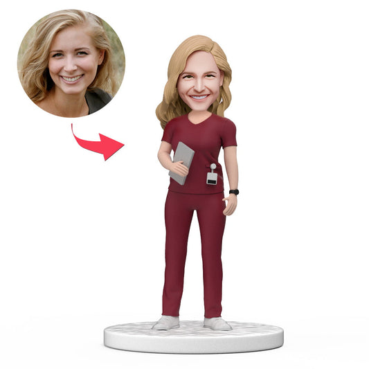 Personalised female doctor bobblehead in red scrubs holding a tablet with engraved base — custom doctor figurine, ideal as a GP gift, medical graduation present or National Doctor’s Day gift in Australia and the UK