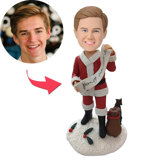 Full-length personalised polymer clay male bobblehead holding a Merry Christmas banner with engraved custom text — personalised Christmas gift for him (dad, partner, friend) — bobble or stationary head options