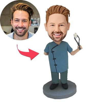 Personalised polymer‑clay dentist bobblehead holding dental forceps with engraved base — customisable head and personalised text, ideal dentist gift