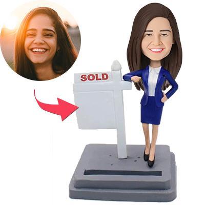 Personalised bobblehead of a female realtor — hand-sculpted polymer clay figurine with a customised head from your photo, fixed professional body and engraved base text; ideal female realtor gift