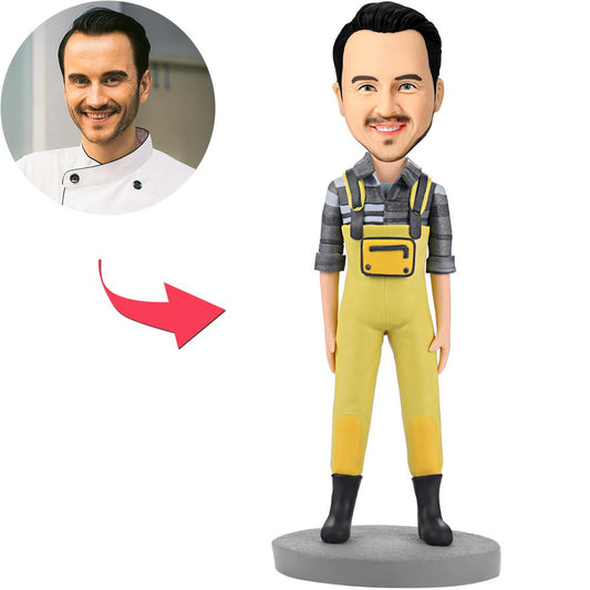 Personalised polymer clay bobblehead of a fashion man in yellow bib pants with customisable head and engraved text option, ideal personalised desk gift
