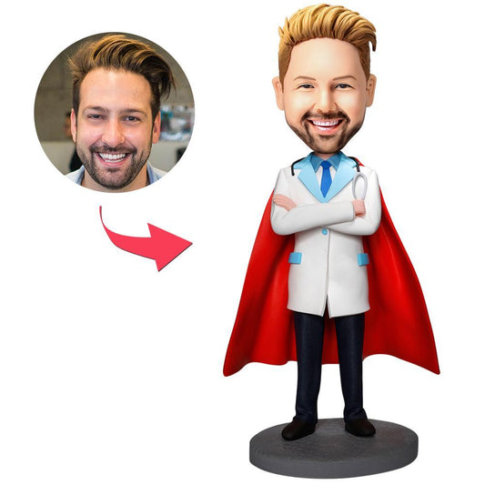 Front view of a personalised Super Doctor bobblehead in polymer clay, customised sculpted head from your photo, wearing a white coat and stethoscope with an engraved base ready for personalised text — made-to-order medical keepsake