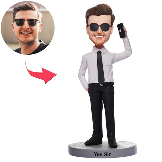 Handmade polymer clay custom man-on-the-phone bobblehead with personalised head, suit and engraved base — custom phone bobblehead and engraved bobblehead keepsake