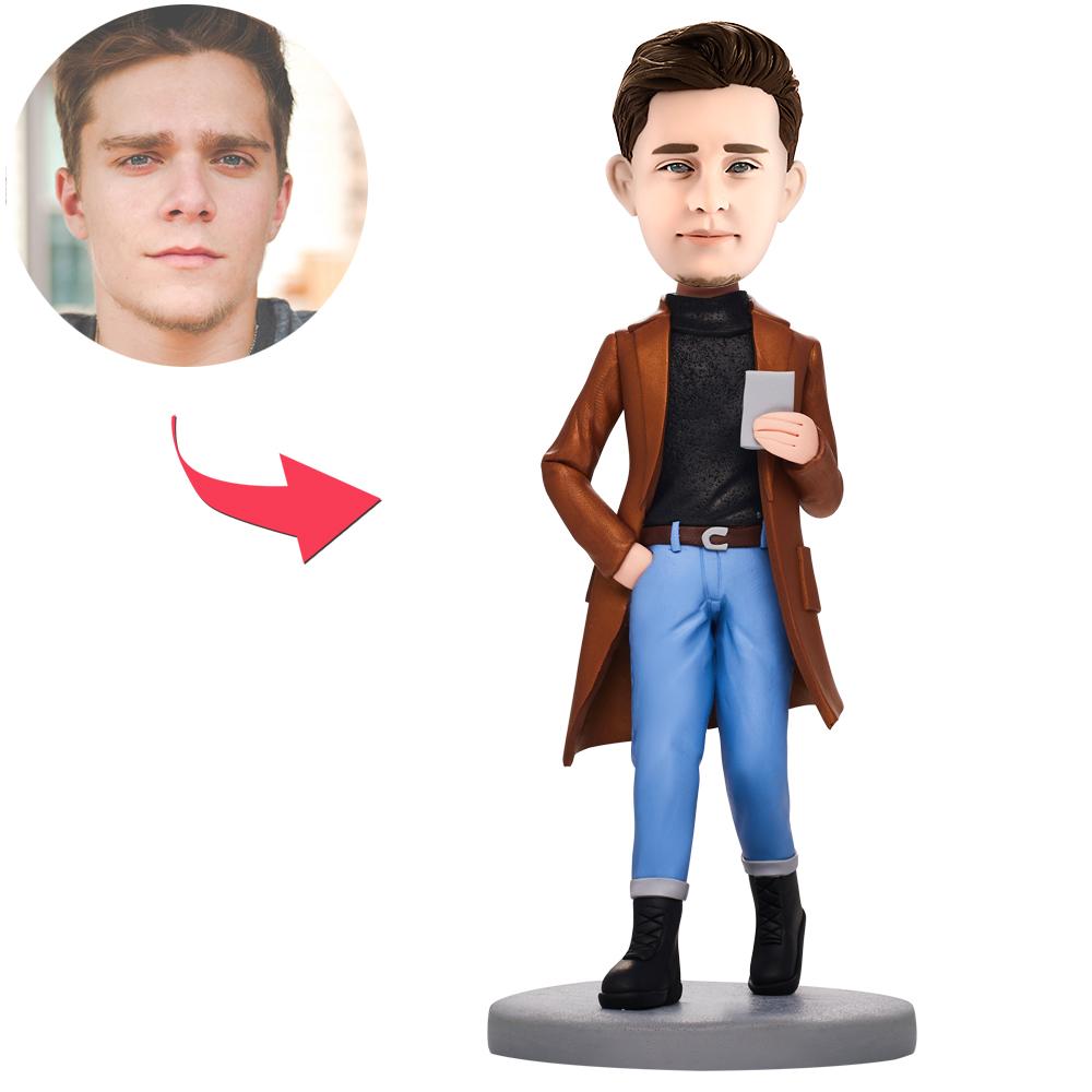 Personalised polymer clay bobblehead of a casual man holding a phone — handcrafted custom bobble head with engraved name on the base, ideal engraved bobblehead gift
