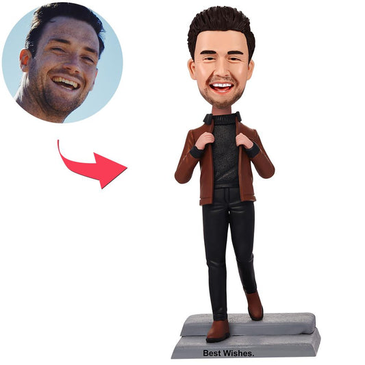 Personalised bobblehead of a man in a brown jacket with engraved text on the base, custom polymer clay head — ideal personalised desk ornament and birthday gift for him
