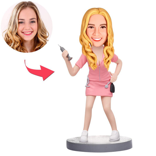 Custom personalised nurse bobblehead in pink uniform, handmade polymer clay face likeness with optional engraved base