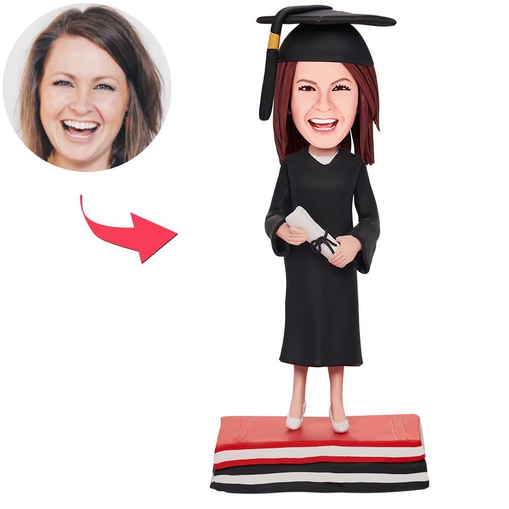 Personalised graduation girl bobblehead in mortarboard and gown — polymer clay bobblehead with engraved base, a bespoke graduation keepsake