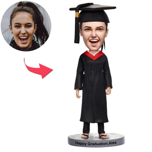 Personalised graduation happy girl bobblehead with engraved text on the base – polymer clay standing figure in graduation gown featuring a customised smiling head sculpt and detailed hairstyle