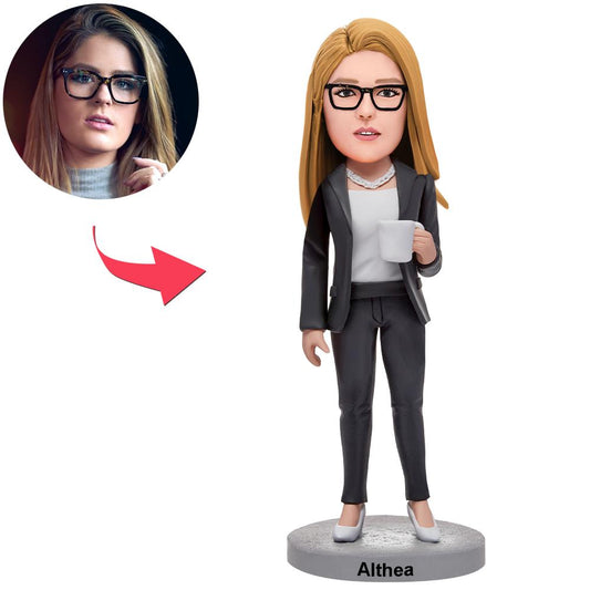 Handcrafted polymer clay personalised business woman bobblehead holding a water glass, engraved name on base — bespoke corporate gift and desk ornament