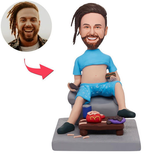 Personalised polymer-clay bobblehead of a man sitting in a chair eating fast food with engraved text on the base — custom bobblehead gift, head personalised only, ideal for Australia and the UK