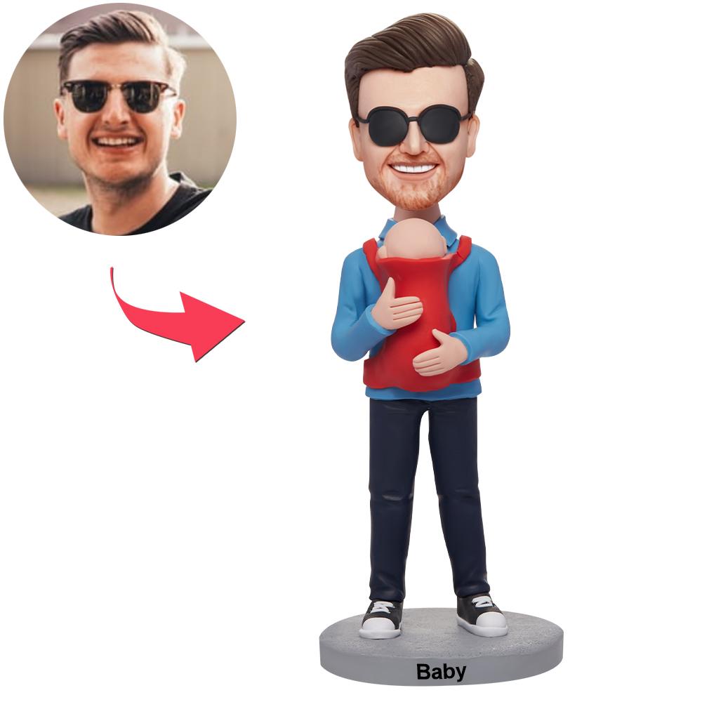 Personalised Dad holding baby bobblehead — polymer clay custom bobblehead with engraved base; personalised head from your photo, perfect new dad gift