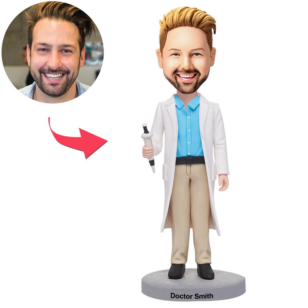 Personalised male doctor bobblehead in polymer clay holding a syringe, customised from your photo with engraved name on the base