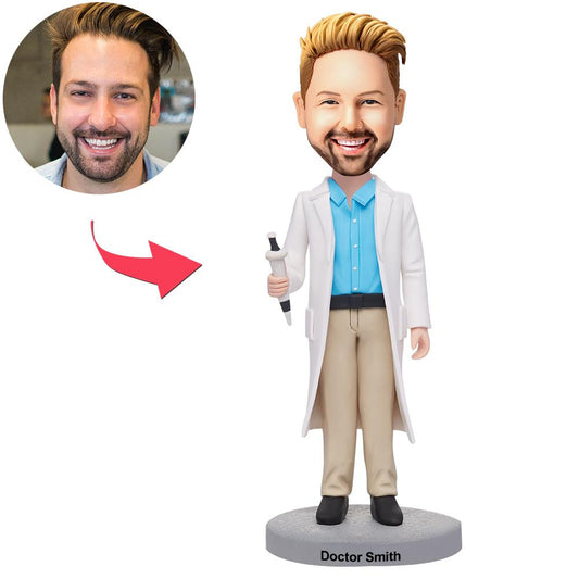 Personalised male doctor bobblehead in polymer clay holding a syringe, customised from your photo with engraved name on the base