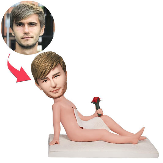 Front view of personalised naked man bobblehead holding a rose, a custom bobble head polymer clay figurine with engraved text on the base