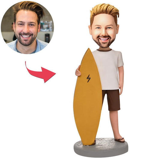 Custom man and surfboard bobblehead personalised with engraved text — polymer clay surfer keepsake with tailored head sculpt; ideal gift for surfers in the UK & Australia