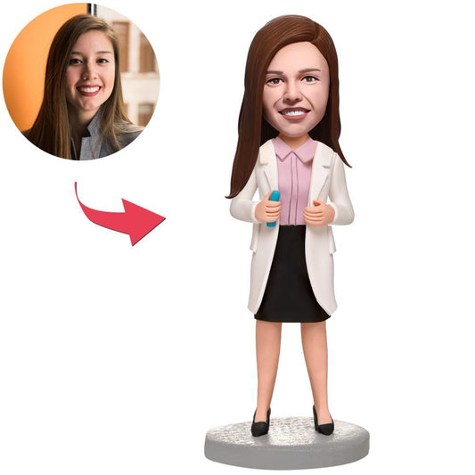 Custom female doctor polymer clay bobblehead holding a needle, personalised head matched to your photo with engraved name on the base — handcrafted medical professional gift