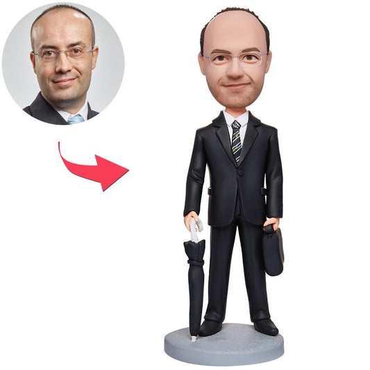 Personalised businessman bobblehead with umbrella and briefcase - handcrafted polymer clay desk ornament with custom sculpted face and engraved text option
