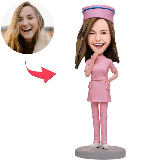 Personalised female nurse custom bobblehead in pink uniform with engraved text on base – handmade polymer clay figurine, fixed or bobble head option, ideal thank-you gift for nurses