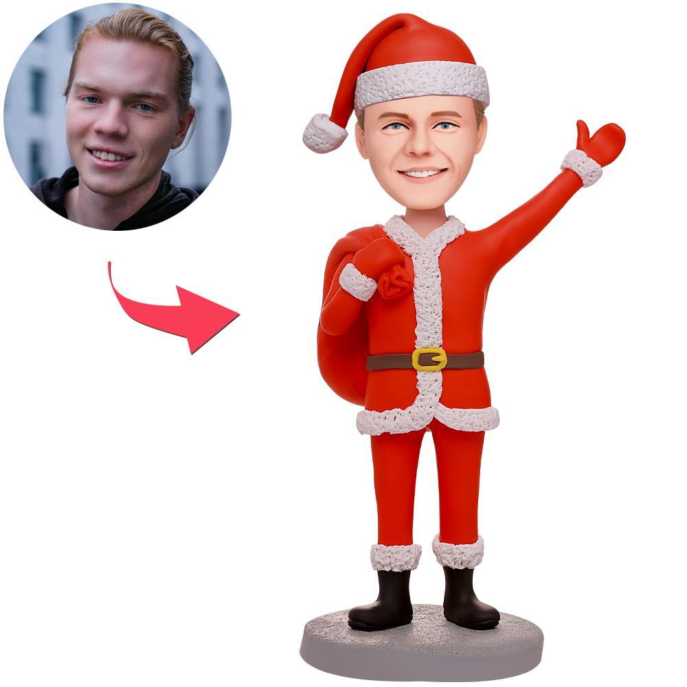 Personalised Santa carrying gifts custom bobblehead with engraved text - front view of polymer clay figurine with personalised head and engraved base, ideal Christmas gift