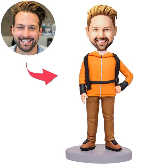 Personalised polymer clay climber bobblehead carrying a bag with engraved text on the base, custom head likeness, ideal gift for climbers and hikers