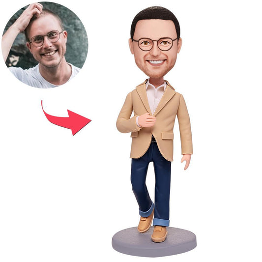 Front view of a custom modern man bobblehead in yellowish-brown outfit, personalised polymer clay figurine with engraved text on the base