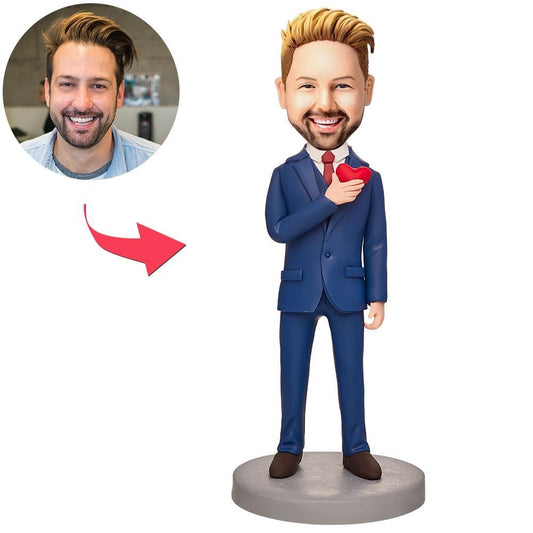 Personalised businessman bobblehead holding a love-heart, polymer clay desk ornament with engraved text on the base — customised head from your photo