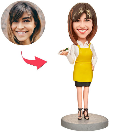Personalised woman holding food bobblehead in polymer clay — custom head with chosen hairstyle and engraved text on base, ideal personalised bobblehead gift