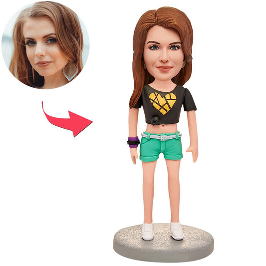 Personalised polymer clay bobblehead wearing a heart T‑shirt; custom head sculpted from your photos with engraved text on the base — the perfect personalised bobblehead gift or keepsake.