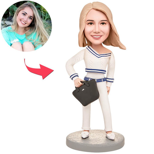 Personalised handcrafted polymer-clay female bobblehead in a white suit with customised head and engraved text on the base, ideal personalised gift