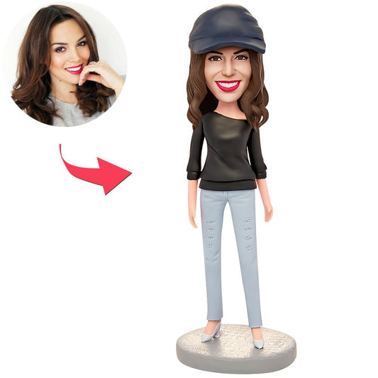 Personalised polymer clay bobblehead of a woman in a black T-shirt with engraved text on the base, handcrafted custom bobble head figurine