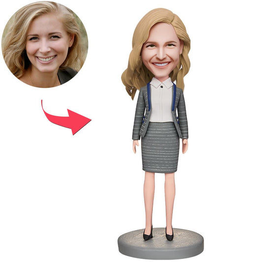 Personalised businesswoman bobblehead with custom face and engraved text on base, hand-sculpted premium polymer clay desk ornament ideal for corporate recognition, personalised gifts and awards
