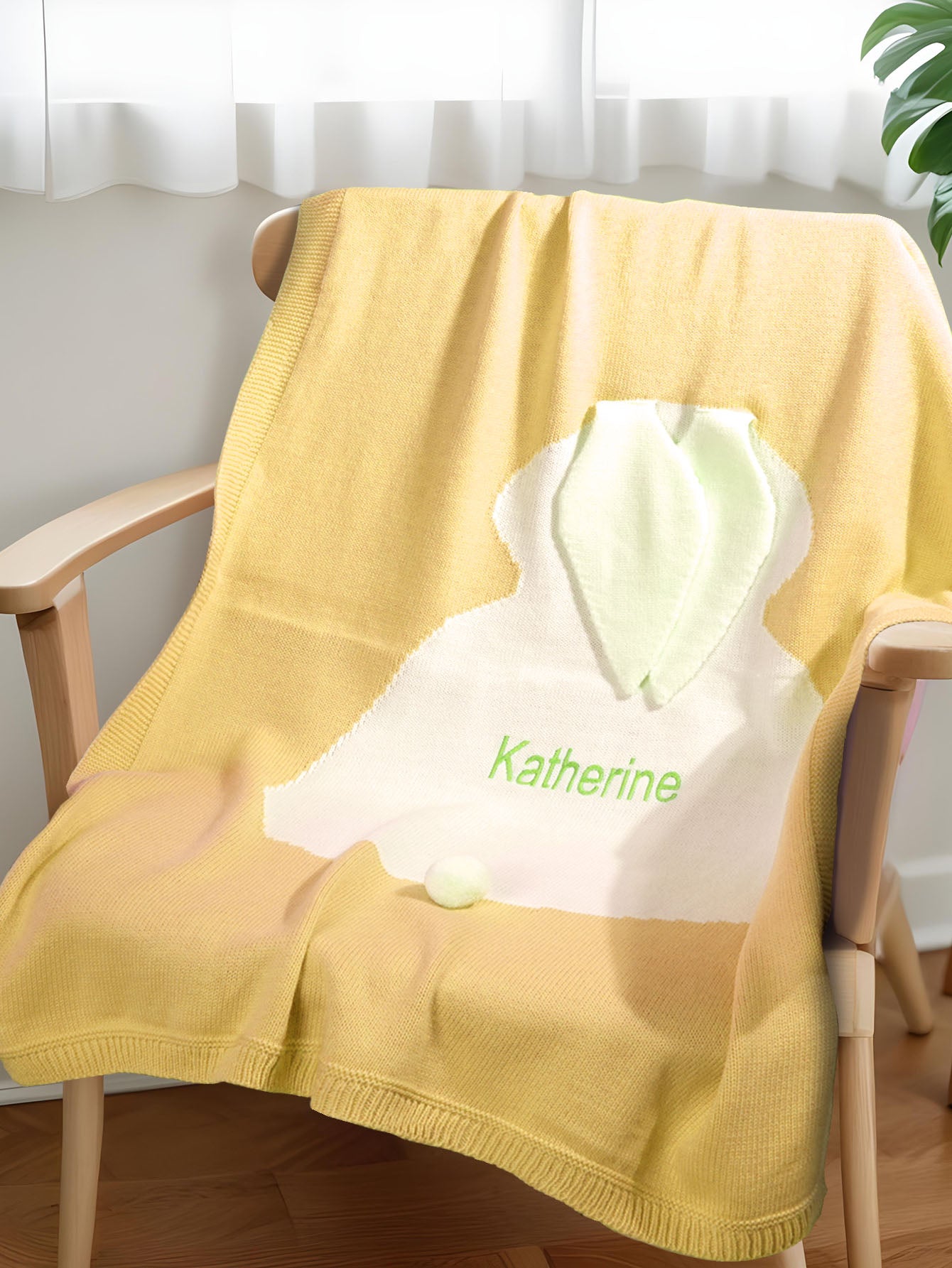 Front view of the personalised knitted bunny baby blanket, highlighting the bunny motif and embroidery.